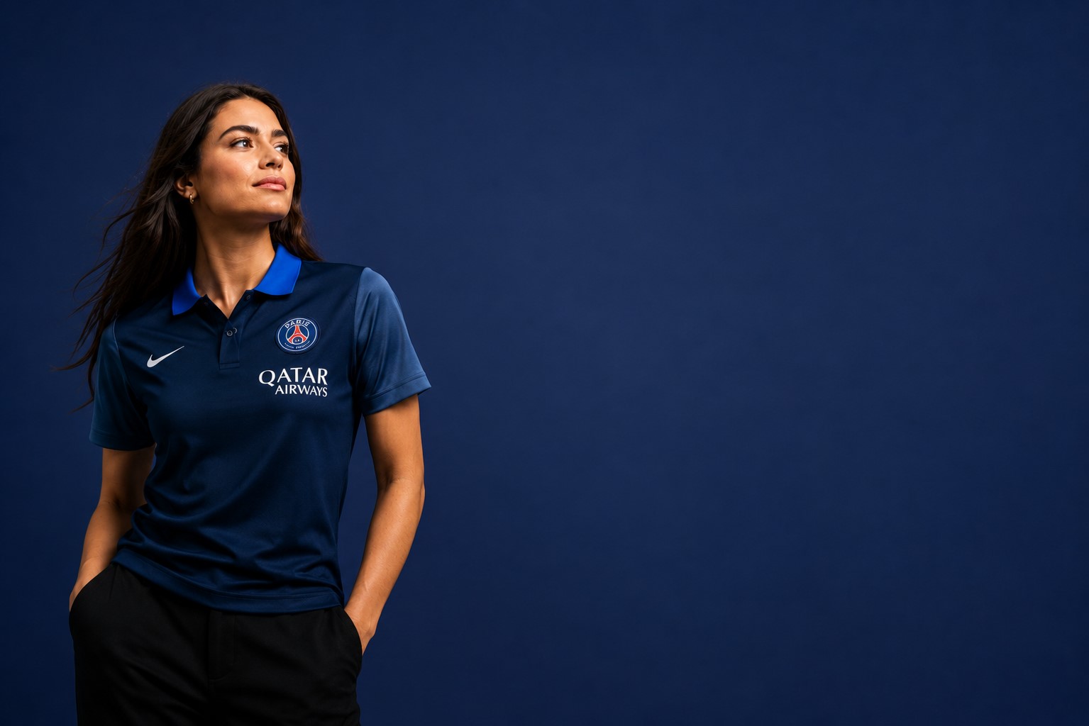 jerseyio Female model wearing premium PSG polo shirt by Jerseyio with elegant blue background football fashion apparel