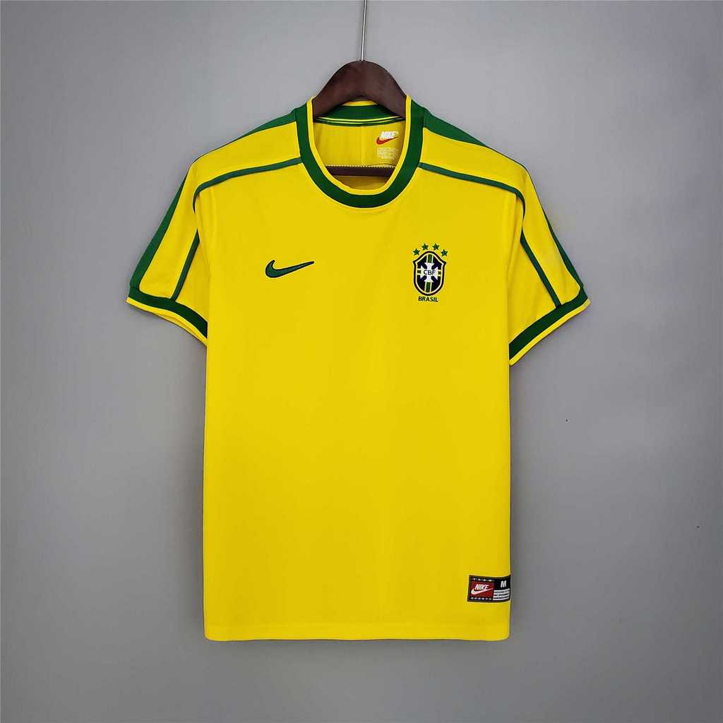 Mens World Cup Brazil Retro Home Jersey 1998 Mens World Cup Brazil Retro Home Jersey 1998 on hanger showing canary yellow body with green piping