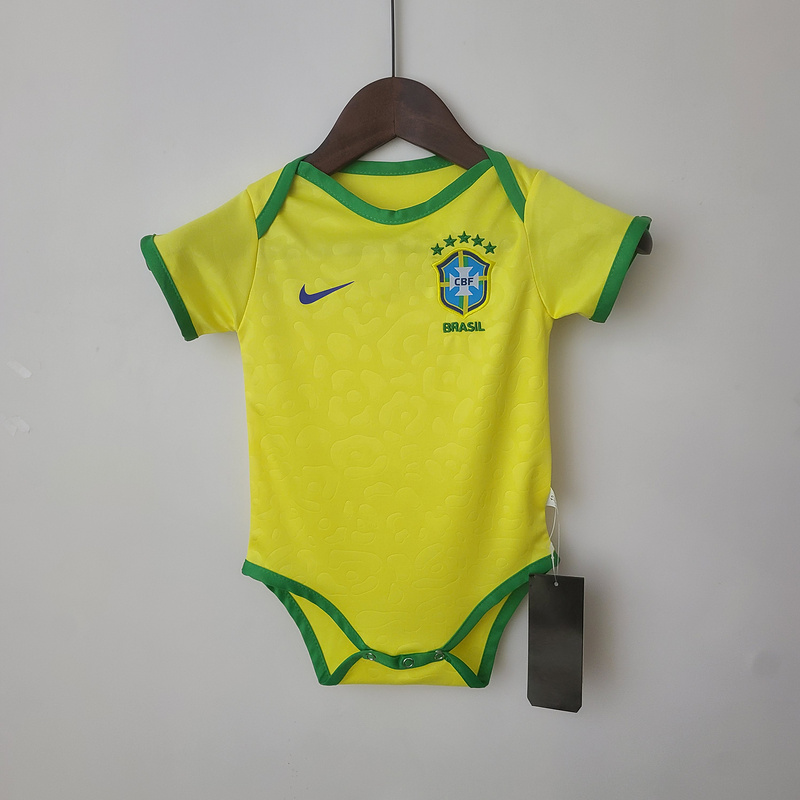 Baby Brazil World Cup Home Jersey 2022 Baby Brazil World Cup Home Jersey 2022 on hanger showing yellow infant bodysuit with green trim and CBF crest