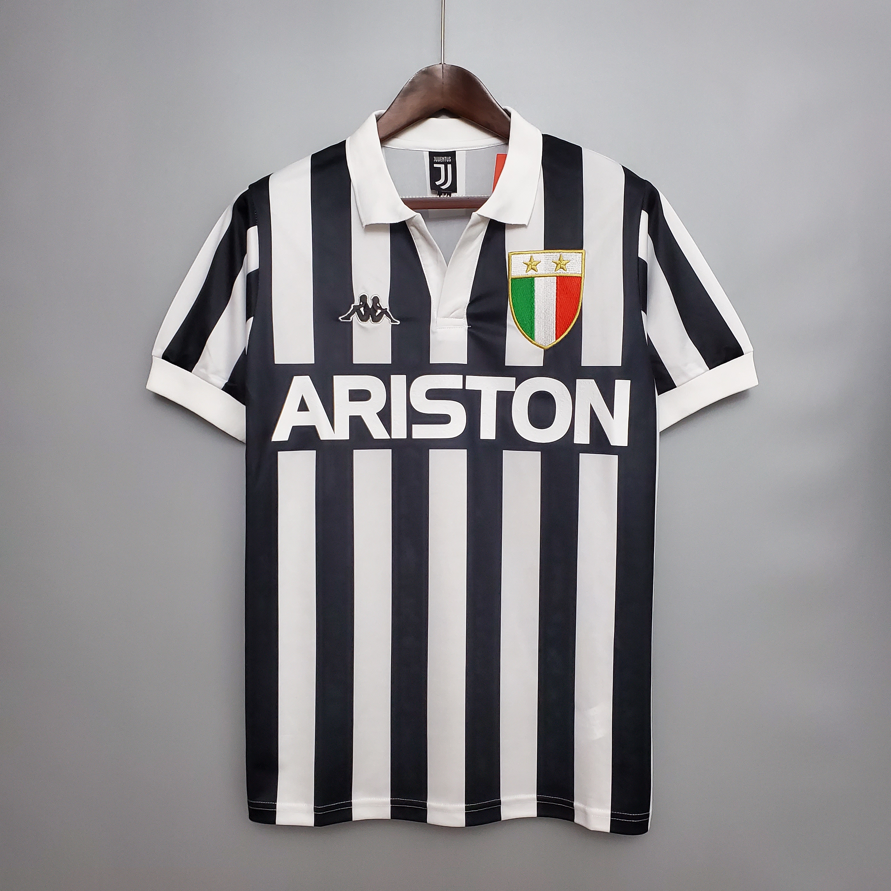Mens Juventus Retro Home Jersey 1982/84 Mens Juventus Retro Home Jersey 1982/84 on hanger showing black and white vertical stripes with Ariston sponsor