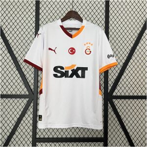 Mens Galata Away Jersey 2024/25 on display showing off-white body with wavy watermark graphics and split orange-maroon collar