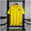 Mens World Cup Brazil Yellow Polo 2022 on hanger showing yellow pique body with green-tipped collar