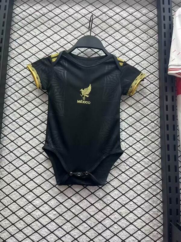 Baby Mexico black Jersey 2025 Baby Mexico black Jersey 2025 on hanger showing embossed tonal feather pattern and golden crest