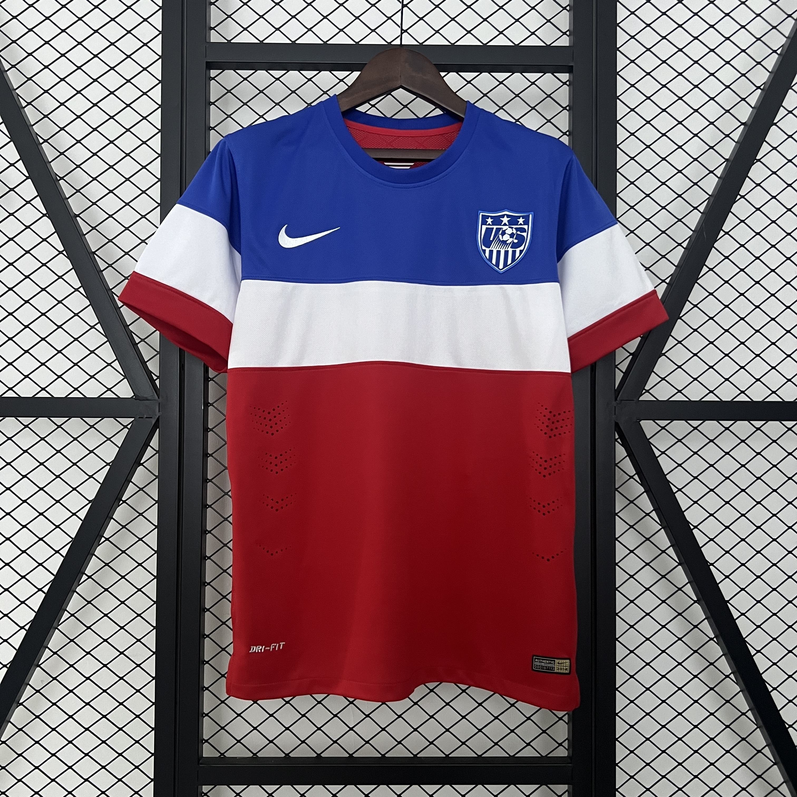 Mens World Cup USA Retro Away Jersey 2014 Mens World Cup USA Retro Away Jersey 2014 front view on hanger showing blue, white, and red color blocks