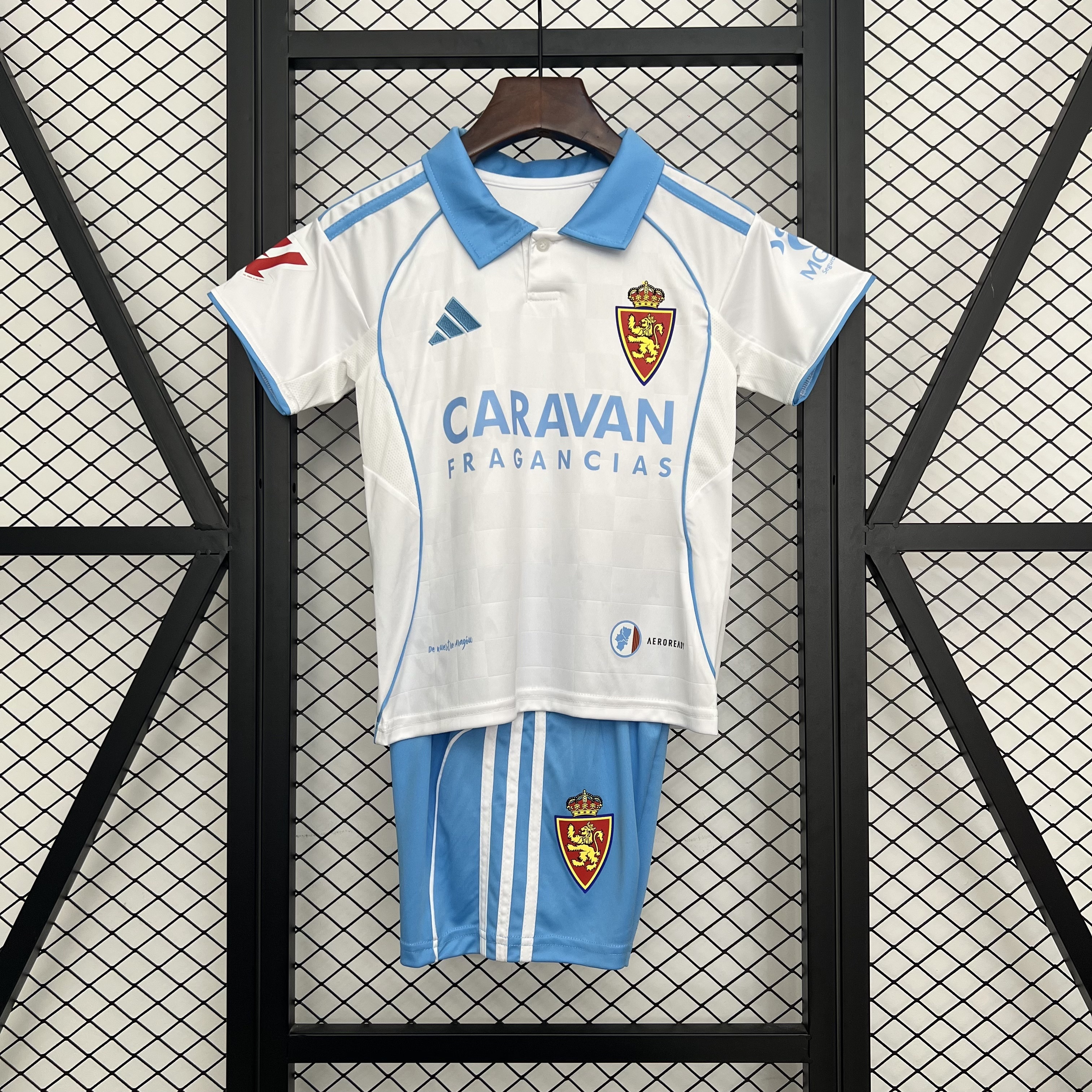 Kids Real Zaragoza Home Kit 2025/26 Kids Real Zaragoza Home Kit 2025/26 front view on display