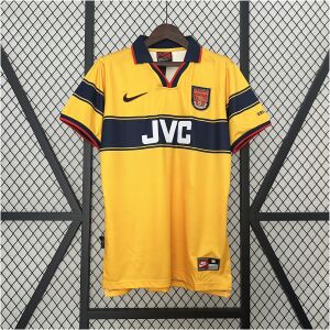 Mens Arsenal Retro Away Jersey 1997/99 on hanger showing yellow body with navy chest stripe, red piping, and JVC sponsor