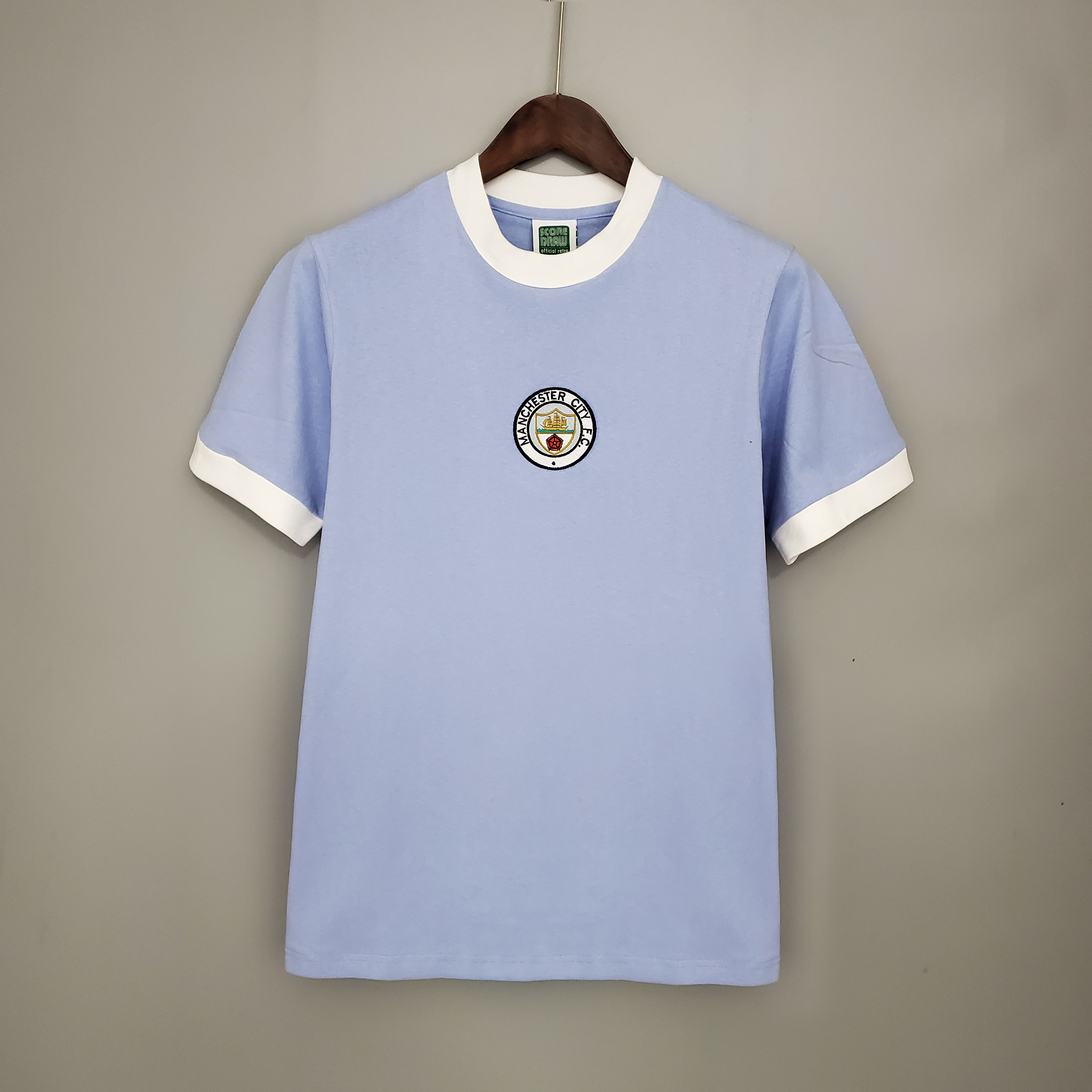 Mens Manchester City Retro Home Jersey 1971/72 Mens Manchester City Retro Home Jersey 1971/72 on hanger showing sky blue ringer shirt with central circular crest