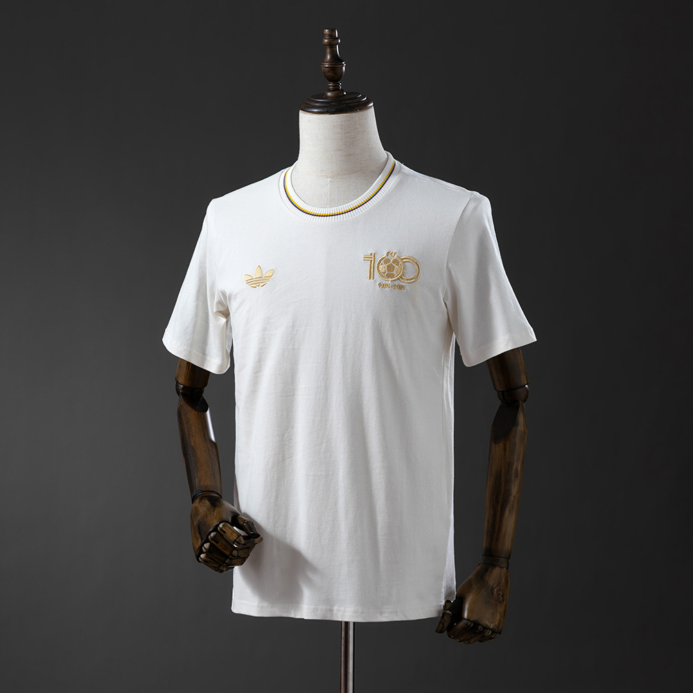Mens Colombia Adidas Wear Chalk White Jersey 2025 Mens Colombia Adidas Wear Chalk White Jersey 2025 front view on mannequin showing gold centenary crest