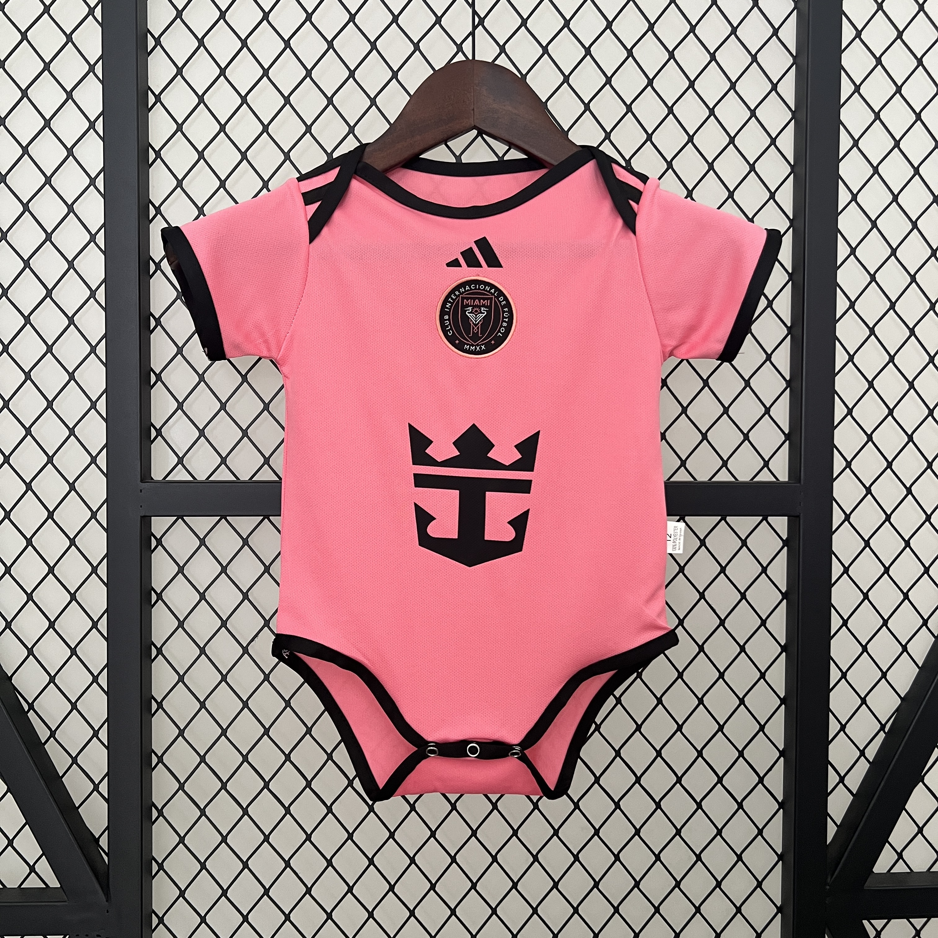 Baby Miami Home Suit 2024/25 Baby Miami Home Suit 2024/25 pink infant bodysuit showing centered crest and sponsor