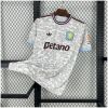 Mens Aston Villa Third Jersey 2025/26 on rack showing off-white mosaic pattern with claret collar and blue trim
