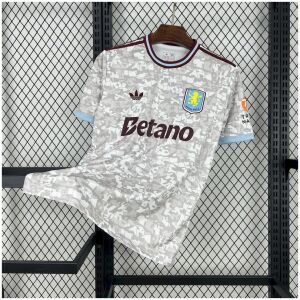 Mens Aston Villa Third Jersey 2025/26 on rack showing off-white mosaic pattern with claret collar and blue trim