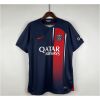Mens PSG Home Jersey 2023/24 on hanger displaying midnight navy body with red-to-blue gradient vertical stripe