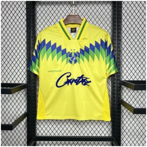 Mens Brazil Corteiz Retro Home Jersey 1995 on hanger showing yellow body with blue and green chevron pattern