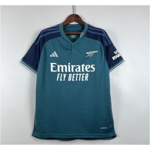 Mens Arsenal Third Jersey 2023/24 on hanger showing mineral teal body with navy raglan sleeves and cannon badge