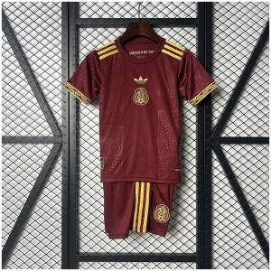 Kids Mexico Red Gold Cup Kit 2025 on hanger showing maroon jersey with gold crest and matching shorts