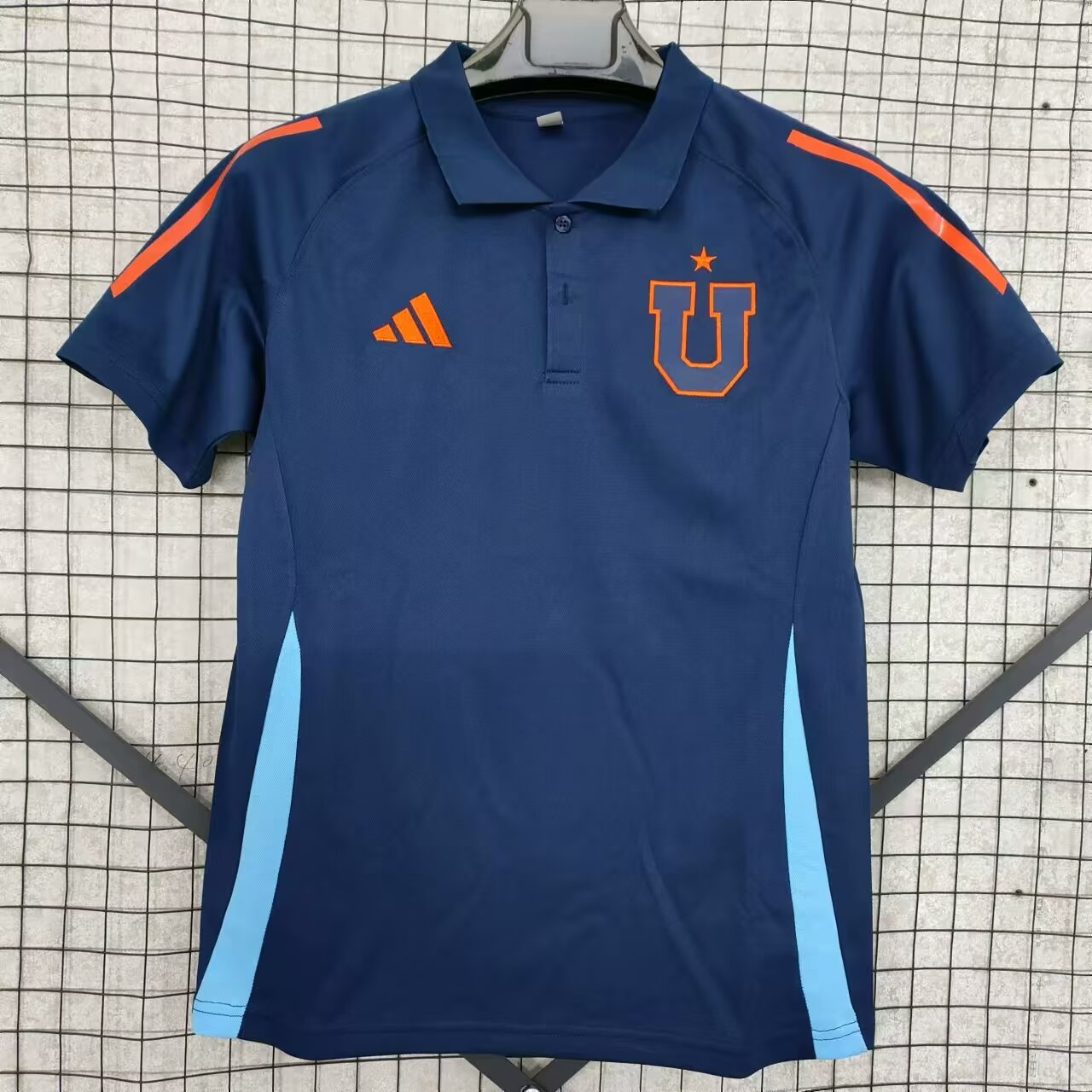 Mens Club Universidad de Chile Polo 2025/26 Mens Club Universidad de Chile Polo 2025/26 front view in navy with orange stripes