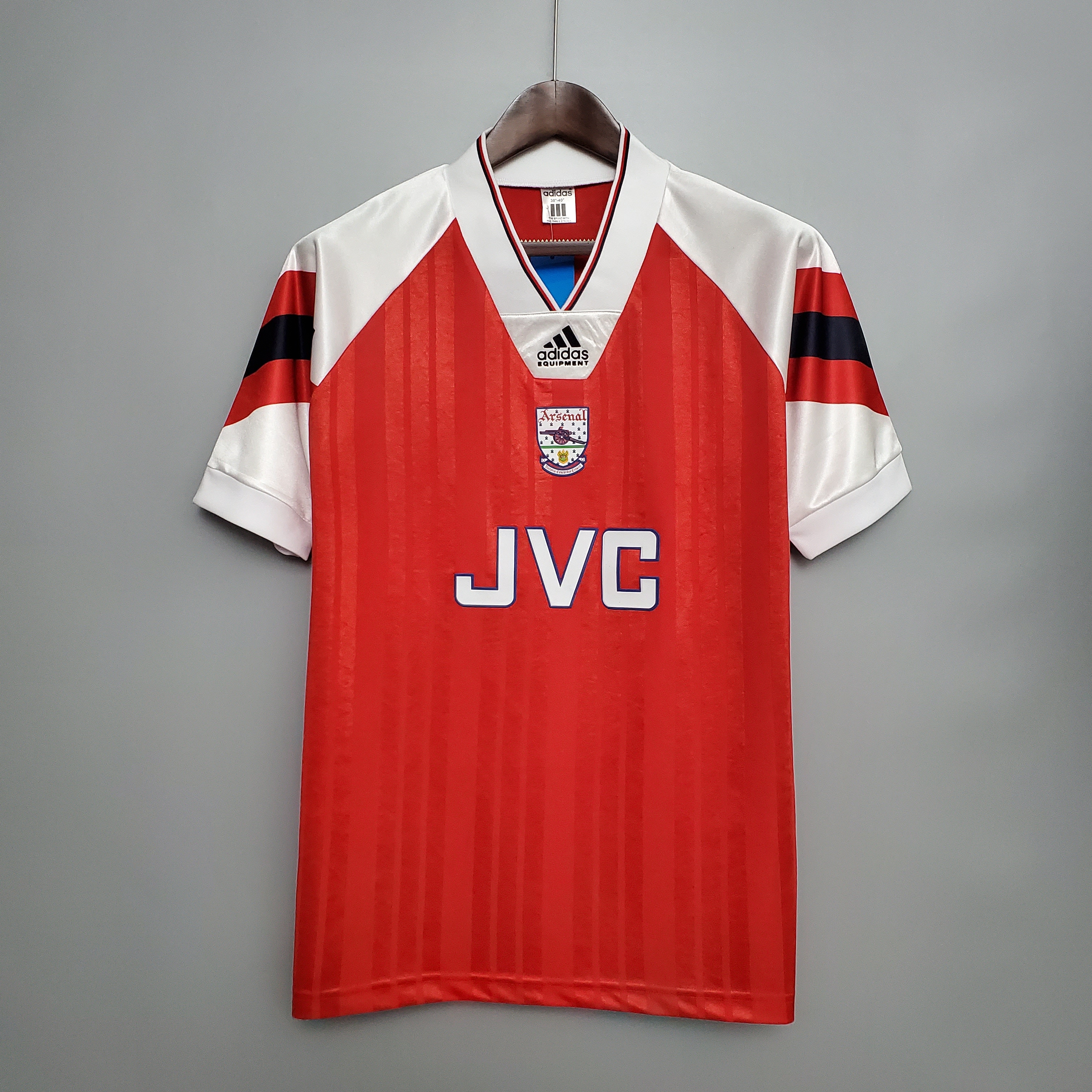 Mens Arsenal Retro Home Jersey 1992/93 Mens Arsenal Retro Home Jersey 1992/93 on hanger showing red body with white sleeves, black and red bands, and JVC sponsor