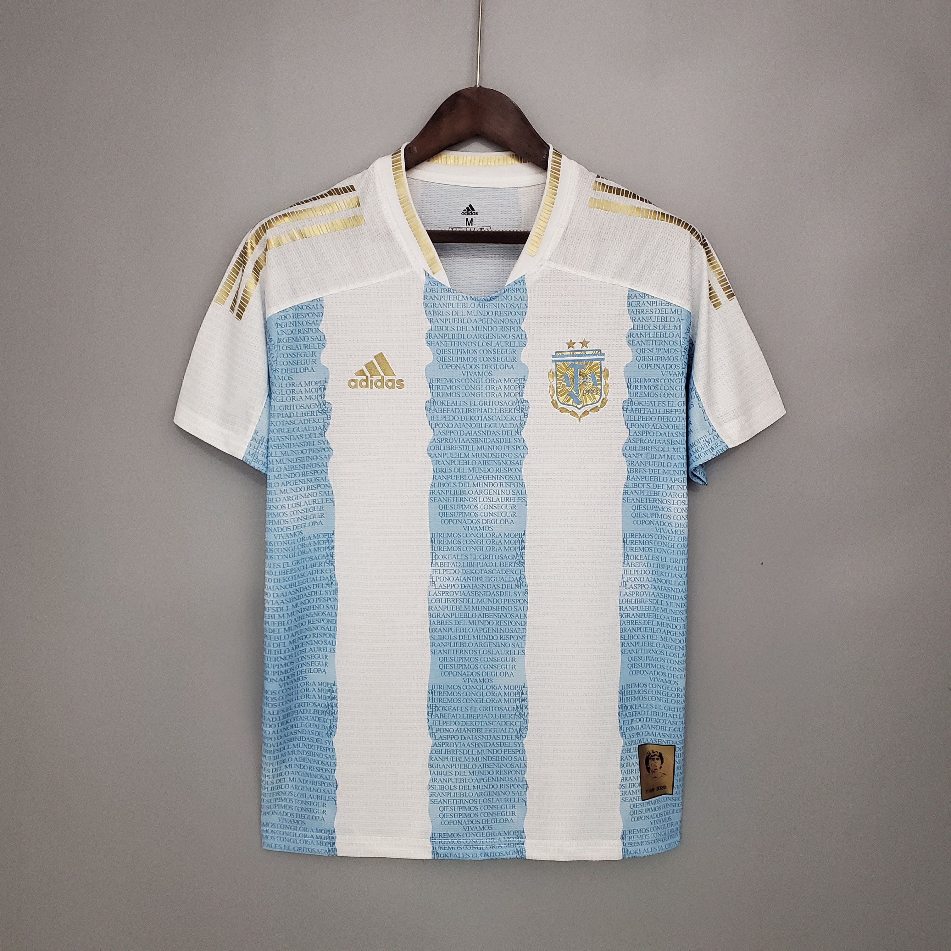 Mens Argentina Commemorative Edition White Blue Retro Jersey 2021 Mens Argentina Commemorative Edition White Blue Retro Jersey 2021 on hanger showing lyric stripes and Maradona patch