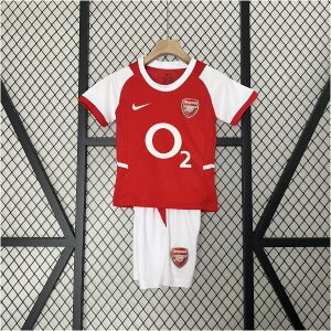 Kids Arsenal Retro Home Kit 2002/04 on rack showing red and white jersey with matching white shorts and O2 logo