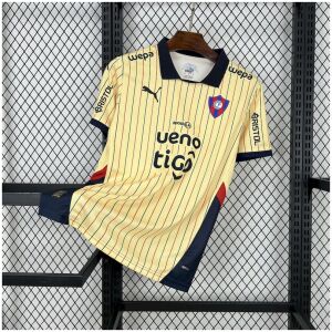 Mens Cerro Porteno Away Jersey 2025/26 on display showing cream body with navy and red pinstripes and dark polo collar