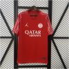Mens PSG Fourth Jersey 2024/25 on hanger showing crimson red body with white Jumpman and PSG crest