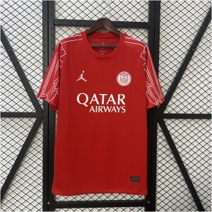 Mens PSG Fourth Jersey 2024/25 on hanger showing crimson red body with white Jumpman and PSG crest