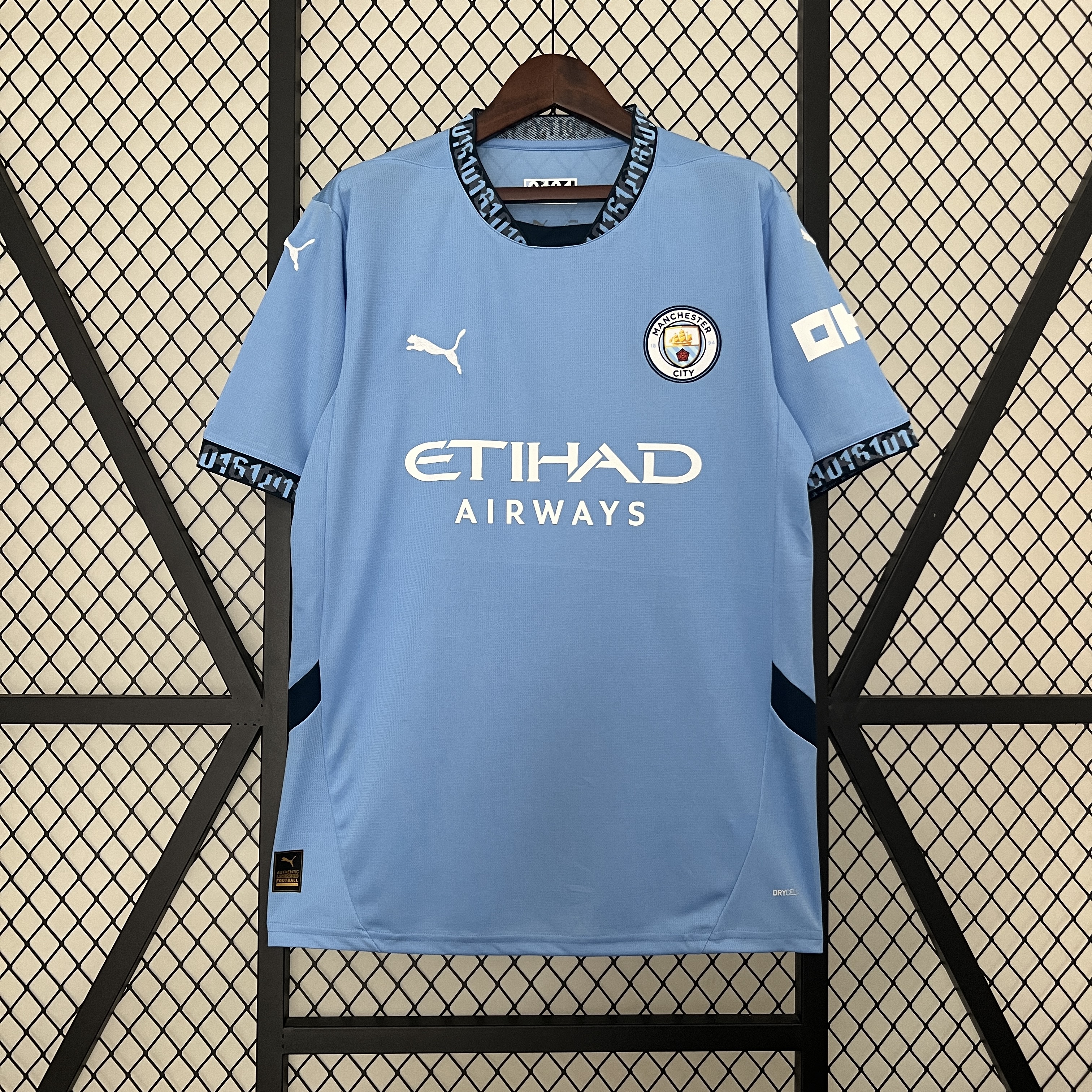 Mens Manchester City Home Jersey 2024/25 Mens Manchester City Home Jersey 2024/25 on hanger showing sky blue body with navy 0161 collar and white sponsor