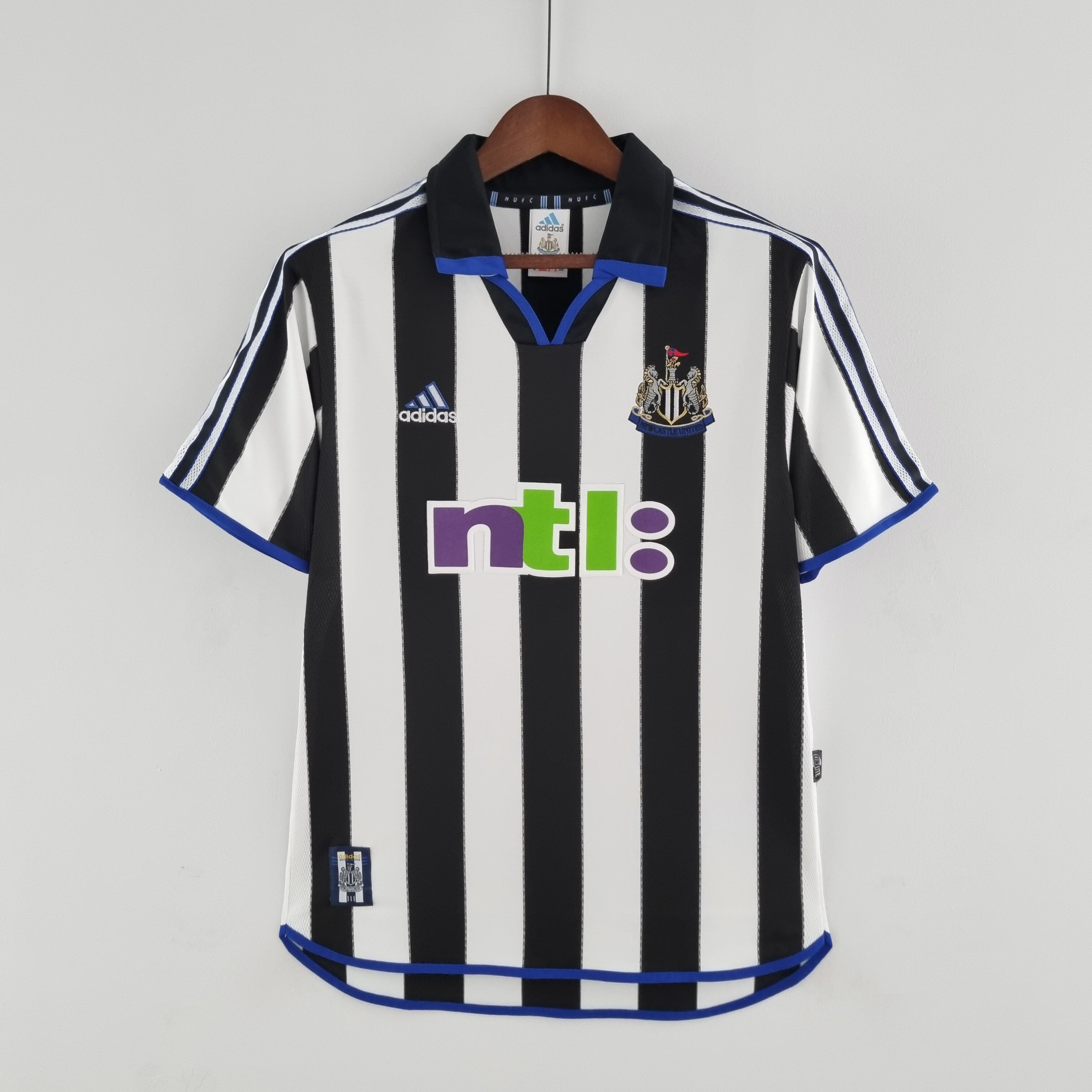 Mens Newcastle United Retro Home Jersey 2000/01 Mens Newcastle United Retro Home Jersey 2000/01 on hanger showing black and white stripes with blue trim and ntl: