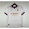 Mens Manchester City Away Jersey 2023/24 on hanger showing off-white body with burgundy collar and copper sponsors