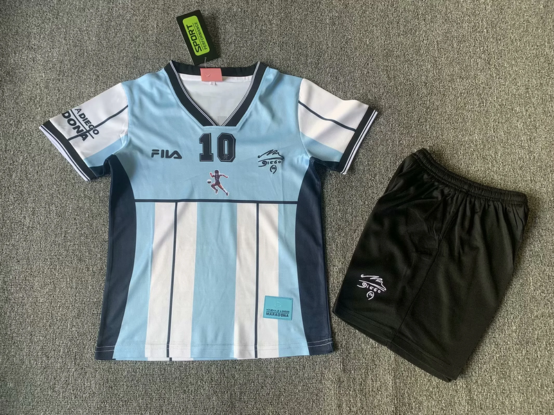 Kids Argentina Maradona Retro Kit 2001 Kids Argentina Maradona Retro Kit 2001 laid flat showing tribute jersey with number 10 and black shorts
