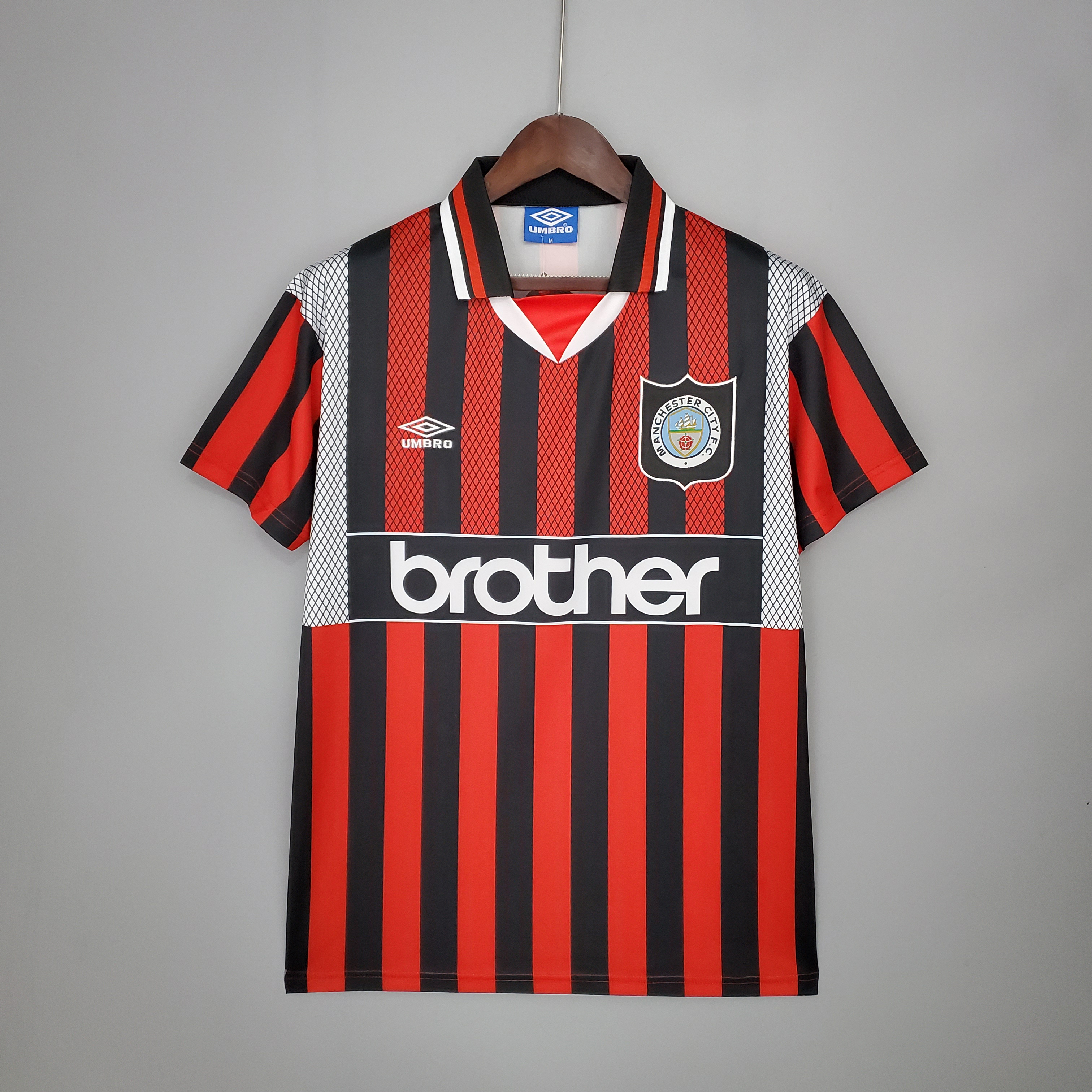 Mens Manchester City Retro Away Jersey 1994/96 Mens Manchester City Retro Away Jersey 1994/96 on hanger showing red and black vertical stripes with brother sponsor