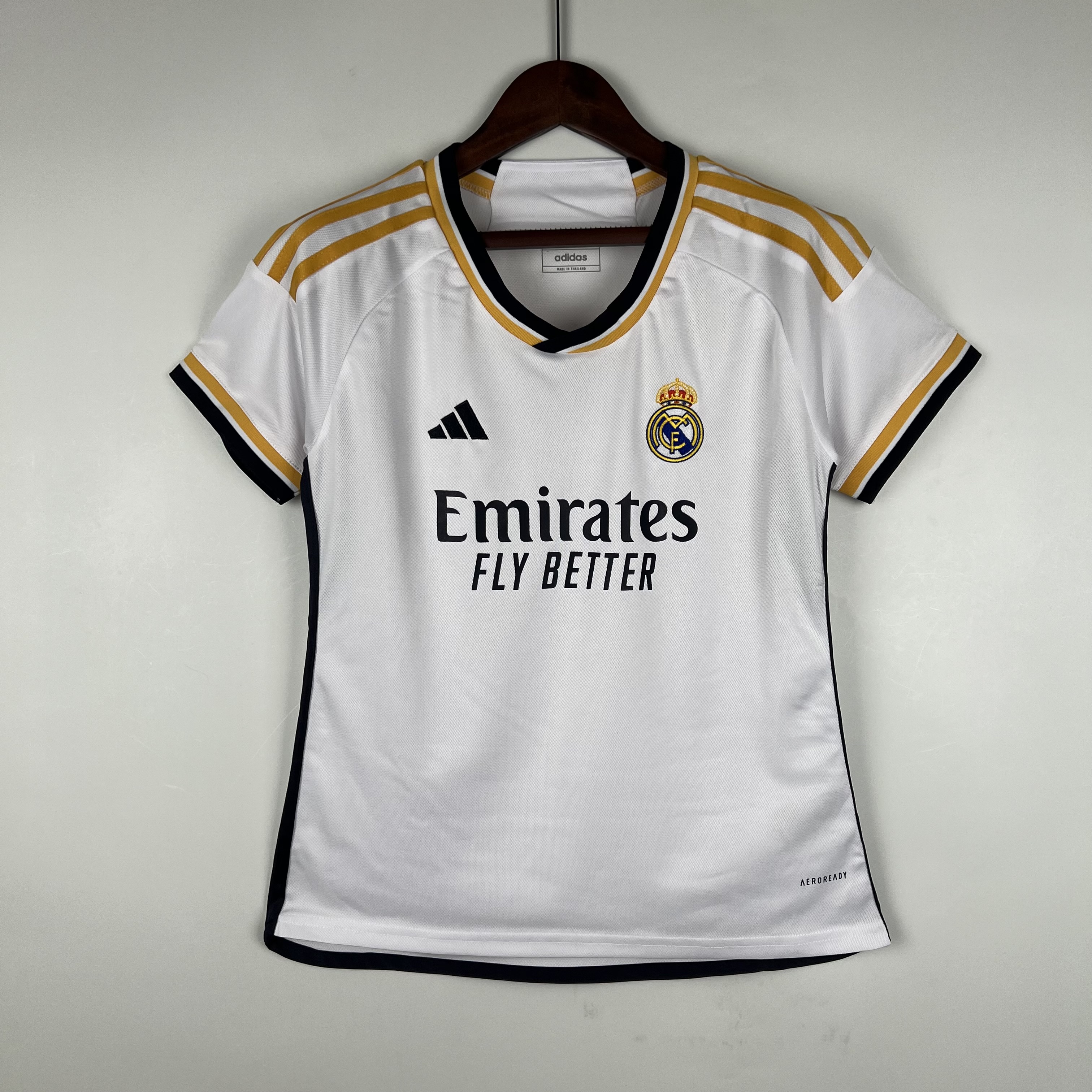 Womens Real Madrid Home Jersey 2023/24 White Real Madrid home shirt with black collar trim and Emirates sponsor front view