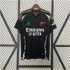 Mens Arsenal Away Jersey 2024/25 on display showing black body with Pan-African red and green accents and geometric side panels