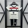 Kids Manchester United Third Kit 2024/25 on hanger showing off-white jersey with tri-color chest band and black shorts