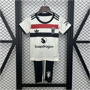 Kids Manchester United Third Kit 2024/25 on hanger showing off-white jersey with tri-color chest band and black shorts
