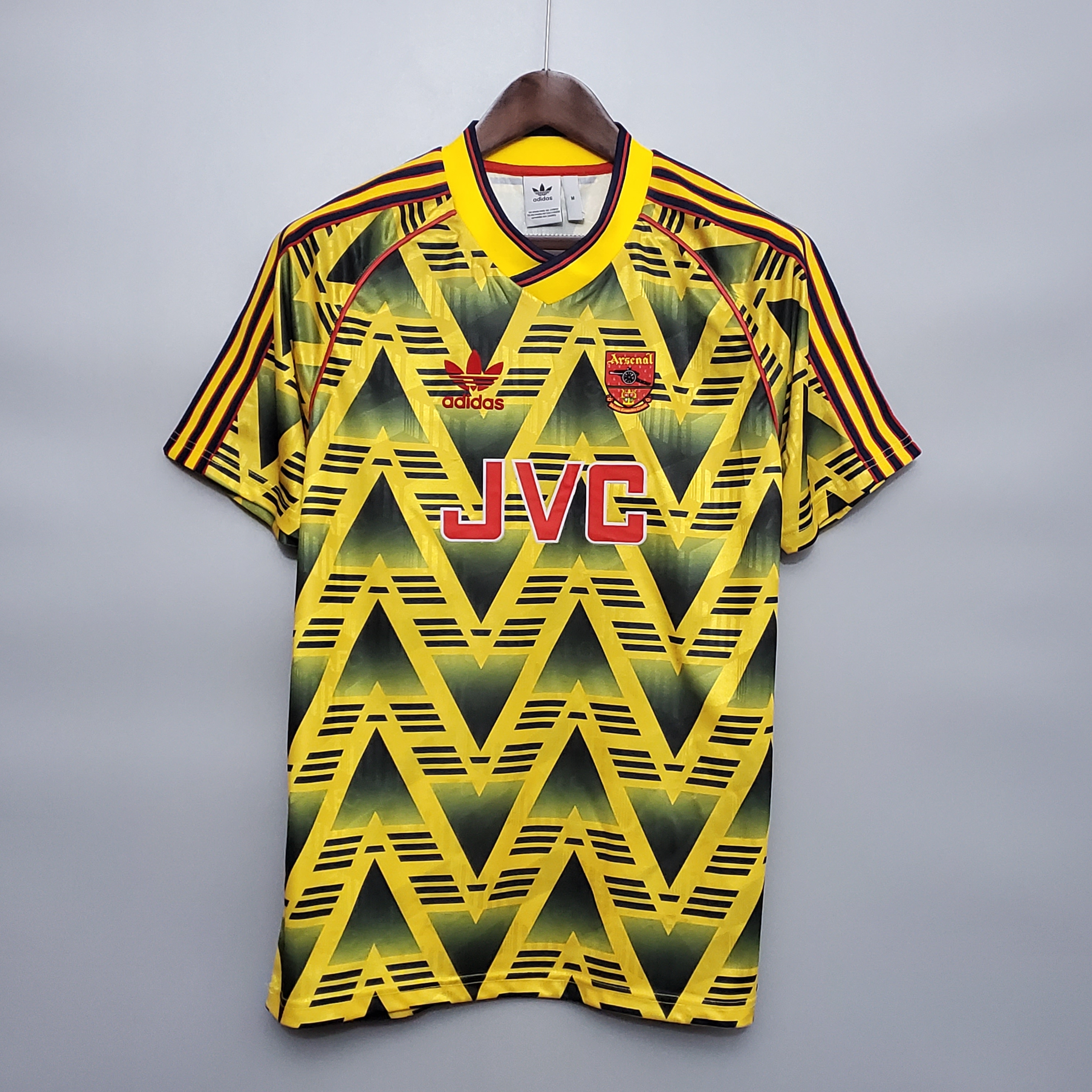 Mens Arsenal Retro Away Jersey 1991/93 Mens Arsenal Retro Away Jersey 1991/93 on hanger showing Bruised Banana yellow and black chevron graphic with red JVC sponsor