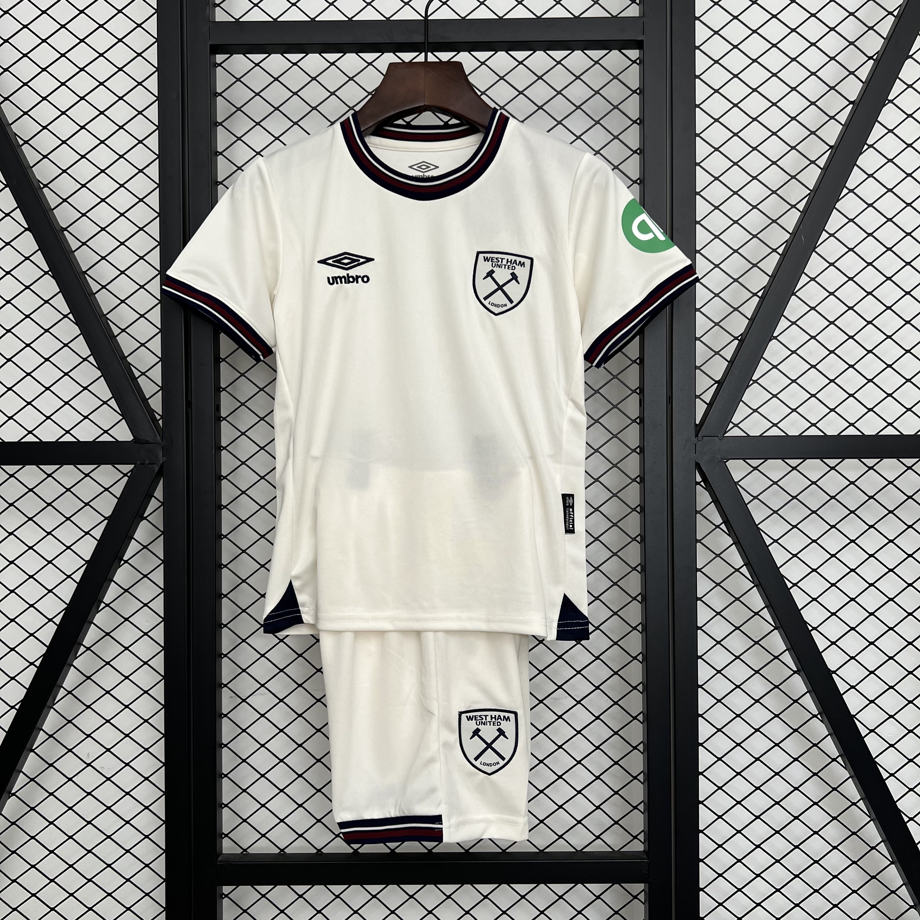 Kids West Ham United Away Kit 2025/26 Kids West Ham United Away Kit 2025/26 set laid flat showing off-white jersey with striped collar and matching shorts