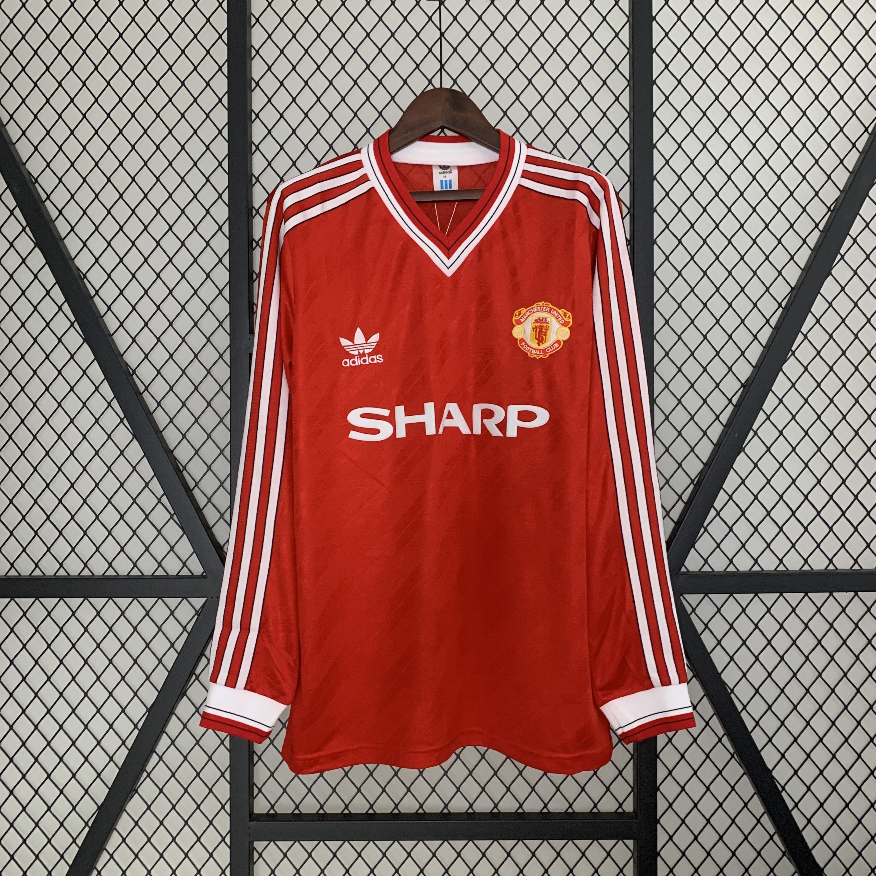 Mens Manchester United Retro Long Sleeve Home Jersey 1986/88 Mens Manchester United Retro Long Sleeve Home Jersey 1986/88 on mannequin showing red body with diagonal shadow stripes