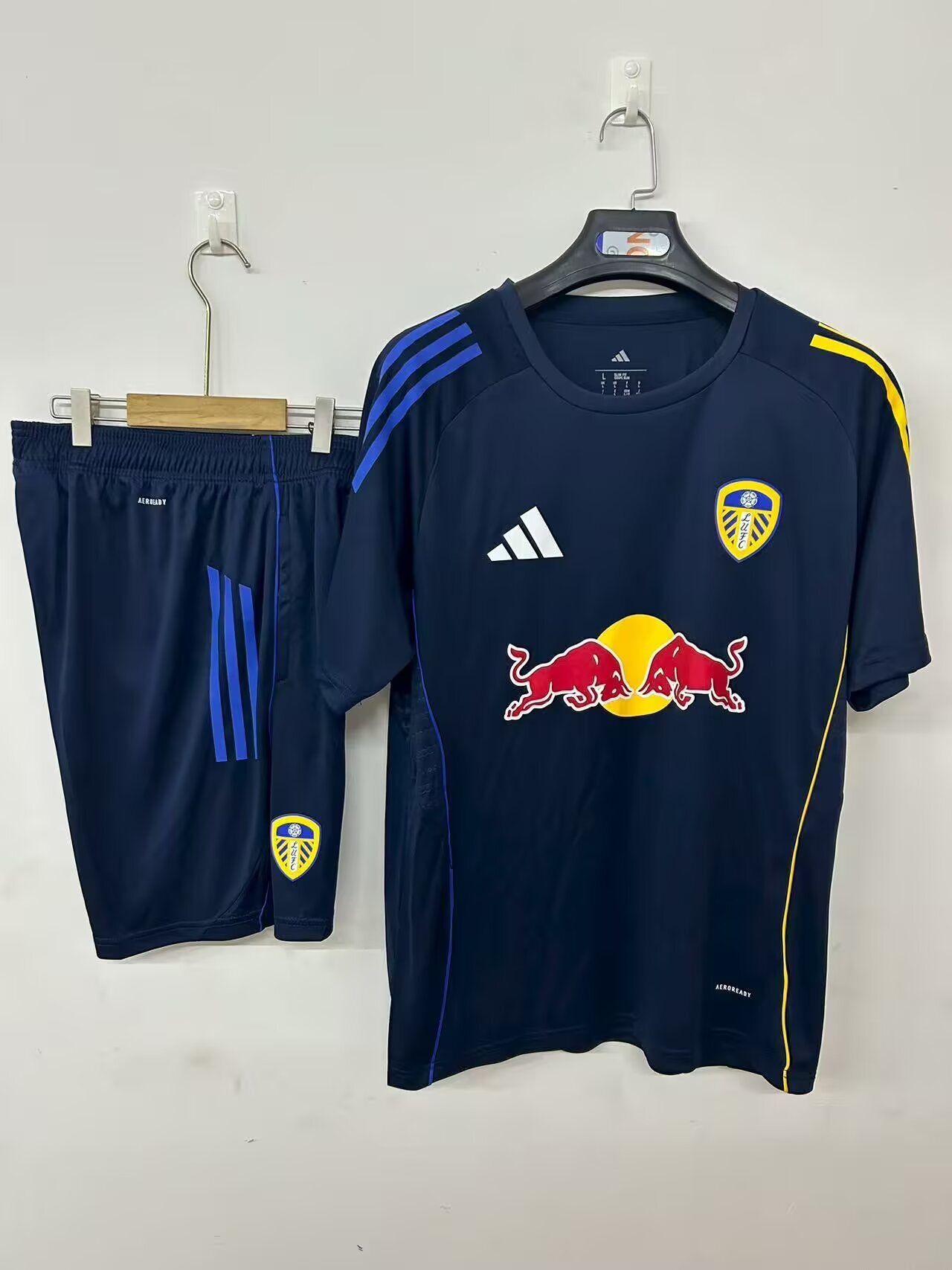 Mens Leeds United royal blue Training Kit 2025/26 Mens Leeds United royal blue Training Kit Kit 2025/26 flat display showing navy top and shorts with asymmetrical stripes