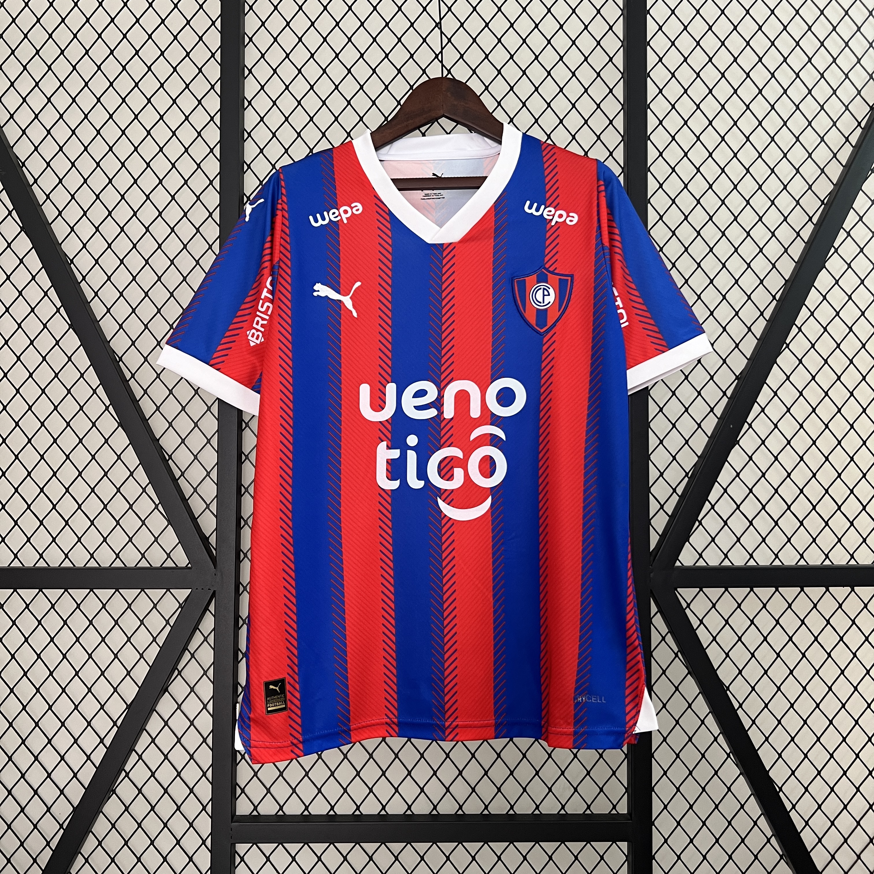 Mens Cerro Porteno Home Jersey 2024/25 Mens Cerro Porteno Home Jersey 2024/25 on display showing blue and red vertical stripes with white V-neck collar and cuffs