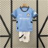 Kids Manchester City Home Kit 2024/25 display showing sky blue shirt with 0161 collar and matching white athletic shorts