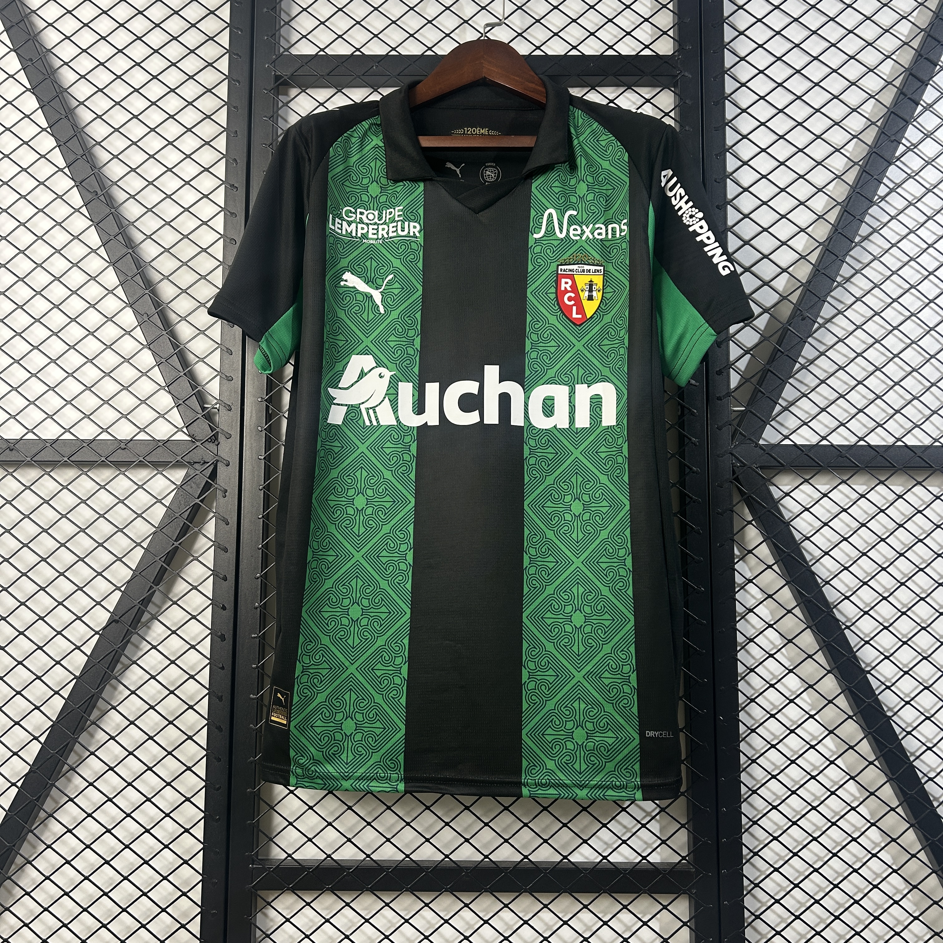 Mens Lens Away Jersey 2025/26 Mens Lens Away Jersey 2025/26 on hanger displaying green and black vertical stripes with damask lace texture