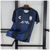 Mens Pachuca Away Jersey 2025/26 displayed on rack showing navy blue body with royal blue gradient vertical stripes