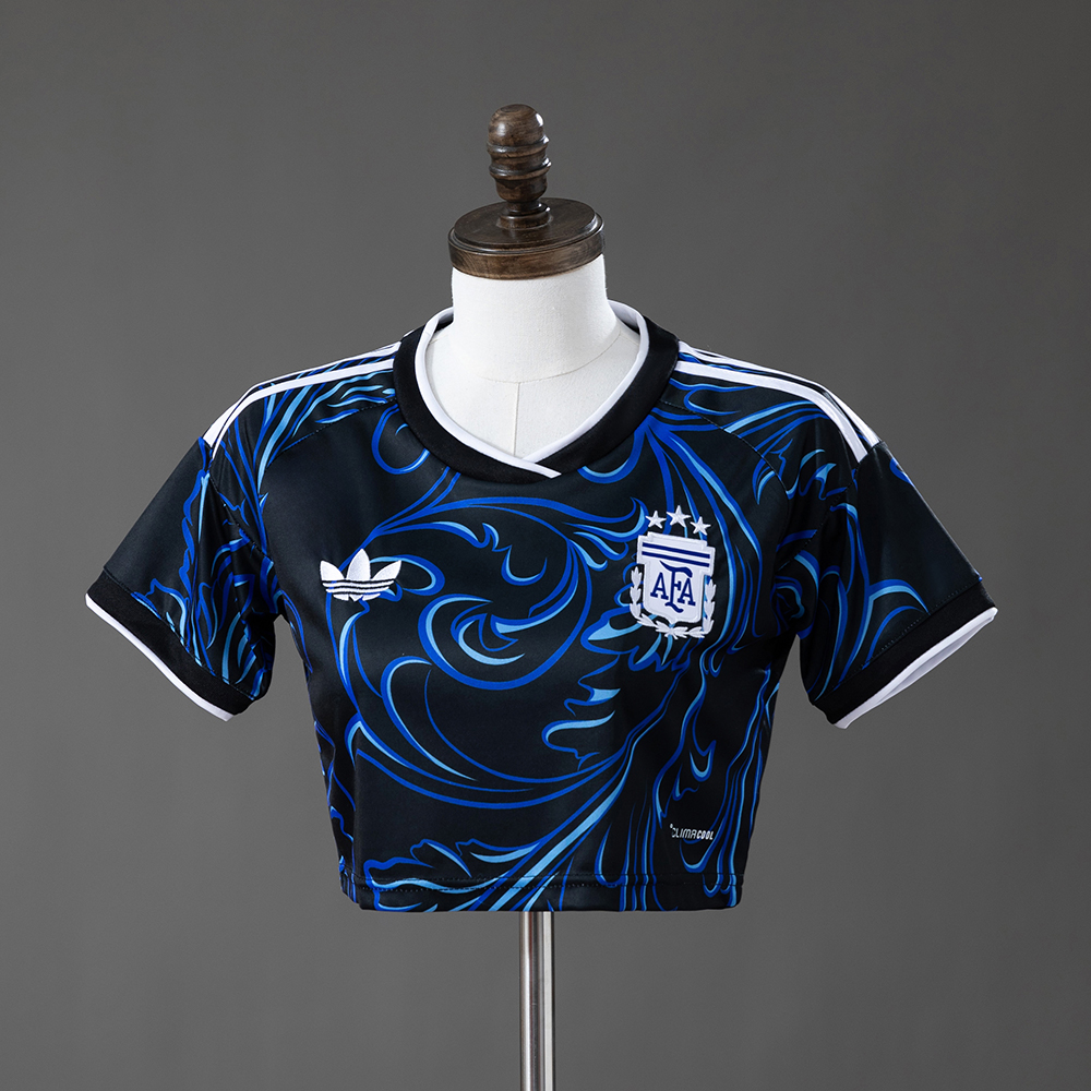 Womens Argentina Style Away Crop Top 2026 Womens Argentina Style Away Crop Top 2026 front view in black with blue marble swirls and three-star AFA crest