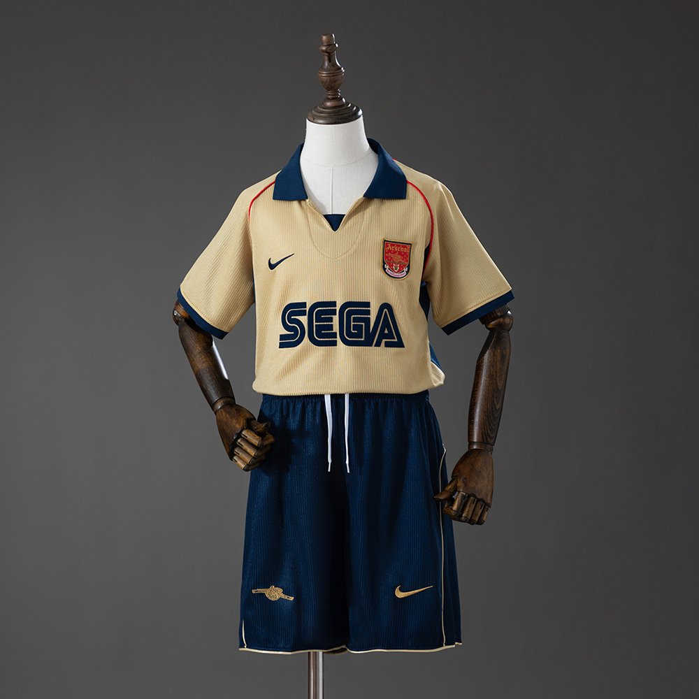 Kids Arsenal Retro Away Kit 2001/02 Kids Arsenal Retro Away Kit 2001/02 front view showing gold jersey with navy collar and matching shorts