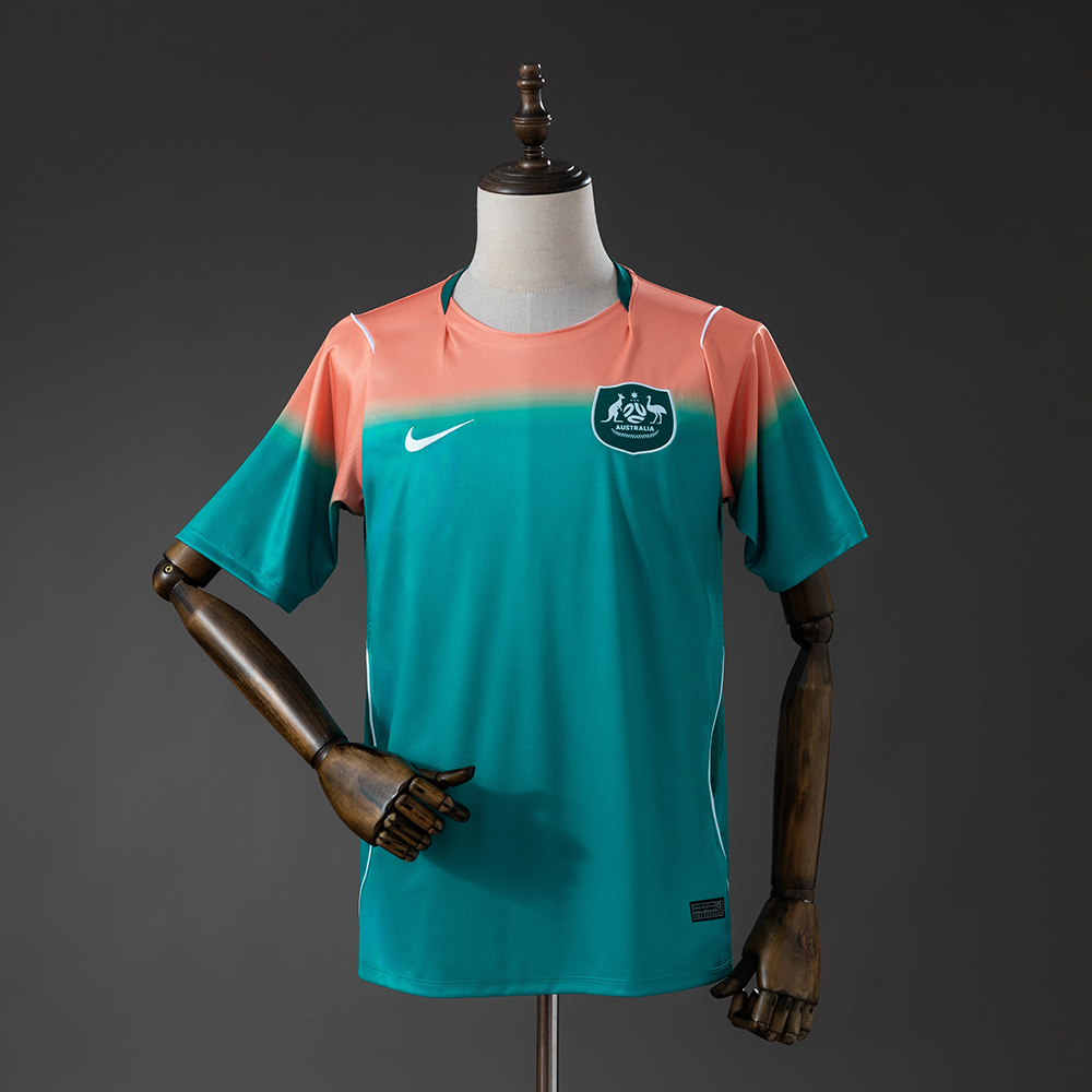 Mens Australia Away Jersey 2026 Mens Australia Away Jersey 2026 front view showing coral and teal gradient with Australia crest