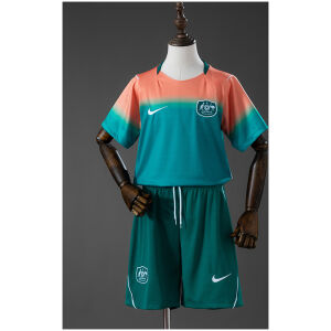 Kids Australia Away Kit 2026 front view featuring peach-to-teal gradient jersey and dark teal shorts