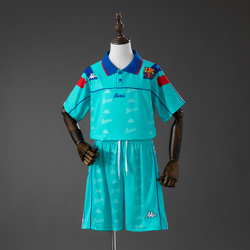 Kids Barcelona Retro Away Kit 1992/95 Kids Barcelona Retro Away Kit 1992/95 front view in turquoise with blue polo collar and matching shorts