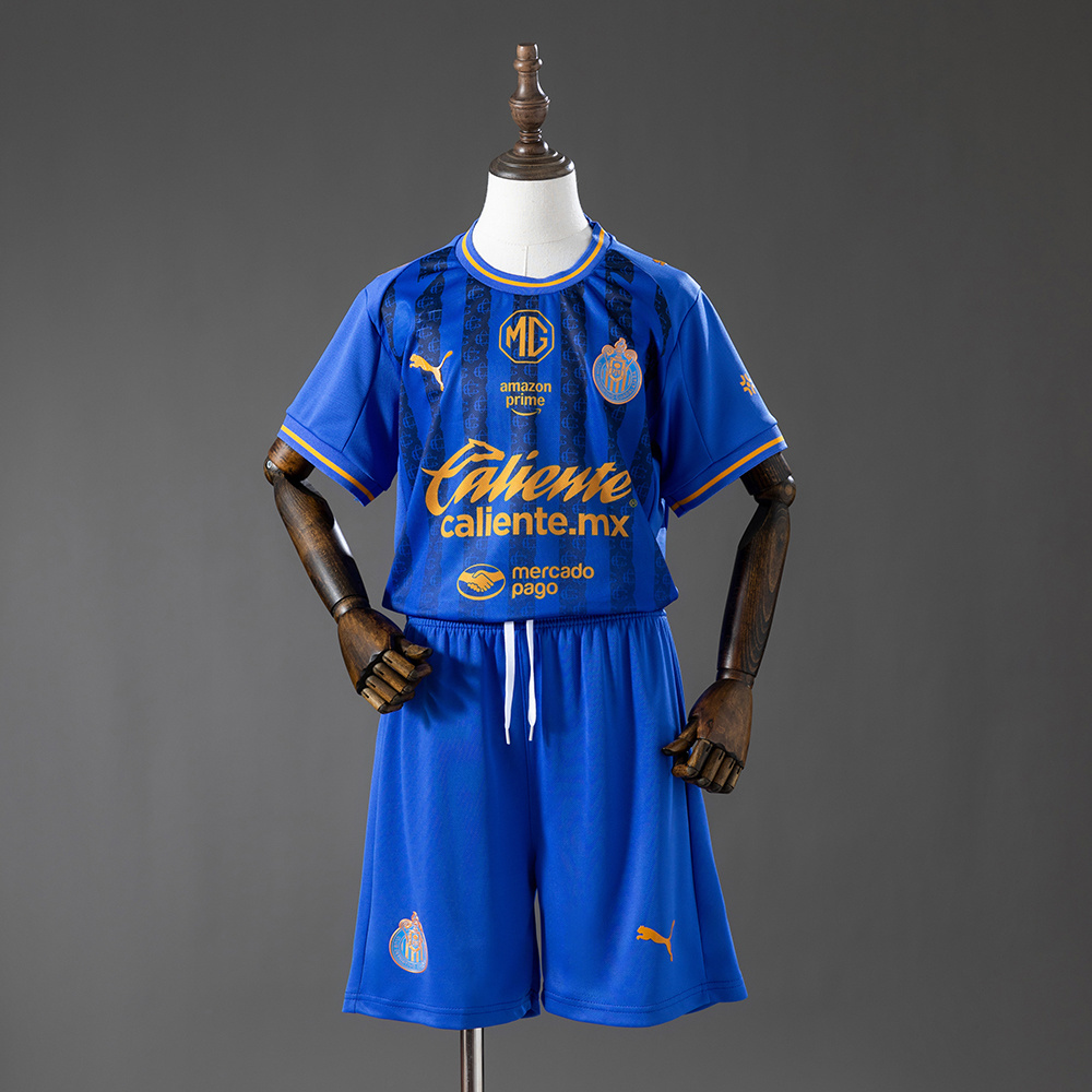 Kids Chivas de Guadalajara Third Kit 2026/27 Front view of the Kids Chivas de Guadalajara Third Kit 2026/27 featuring royal blue jersey with gold sponsors and blue shorts