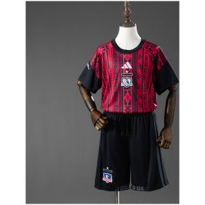 Front view of the Kids Colo Colo Pre-Match Kit 2026/27 displaying red and black tribal pattern jersey and black shorts